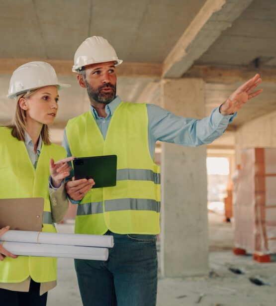 Construction,Site,Supervisor,And,Architect,In,Safety,Vests,And,Helmets
